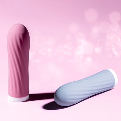 Pink and blue bullet vibrators on a pink background