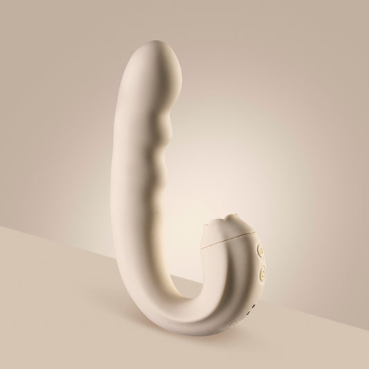 Vanilla clitoral licking vibrator standing upright on cream surface