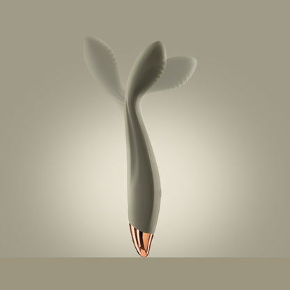 Green G-spot vibrator standing upright with visible motion in head, green background

