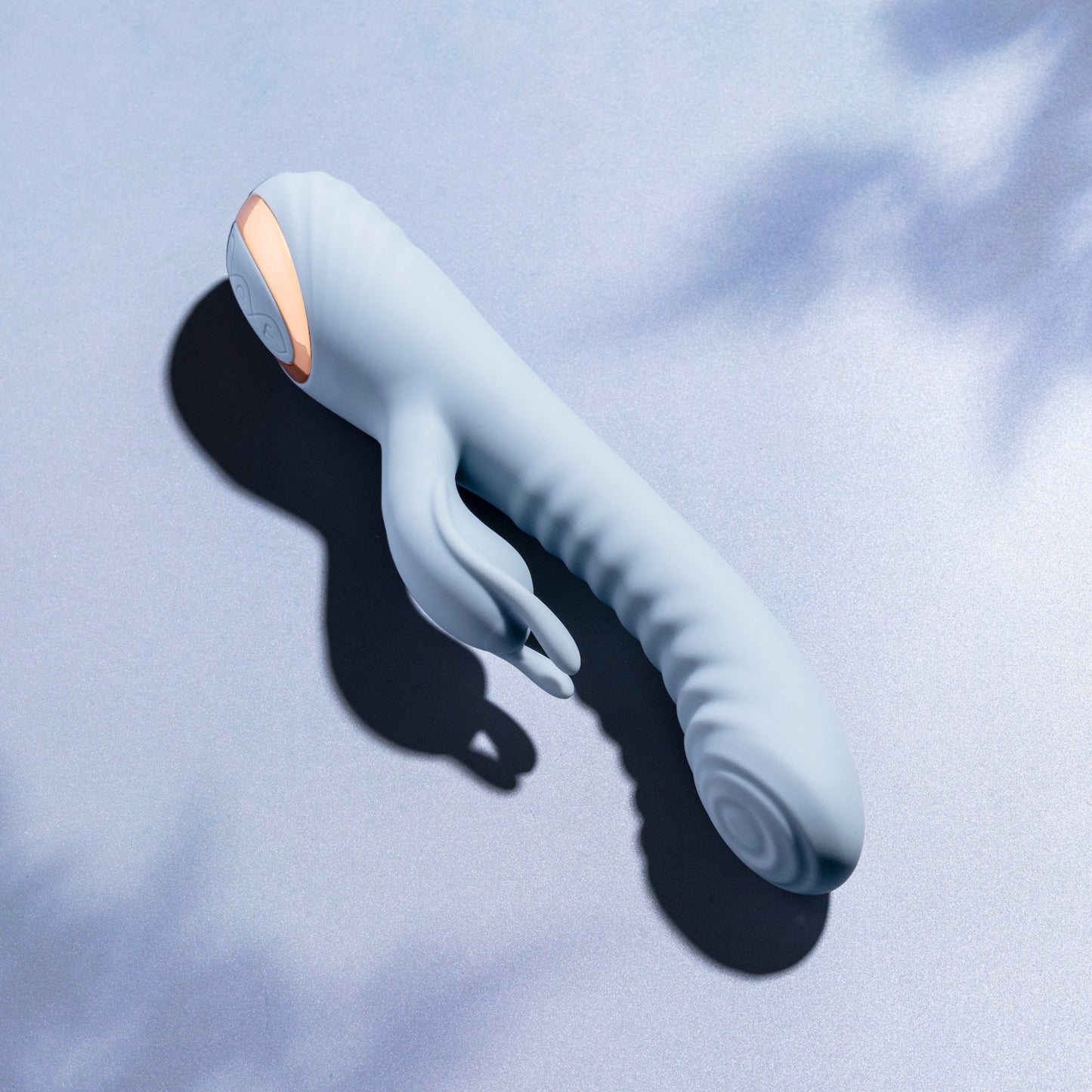 Blue rabbit vibrator with a gold accent on a light blue background