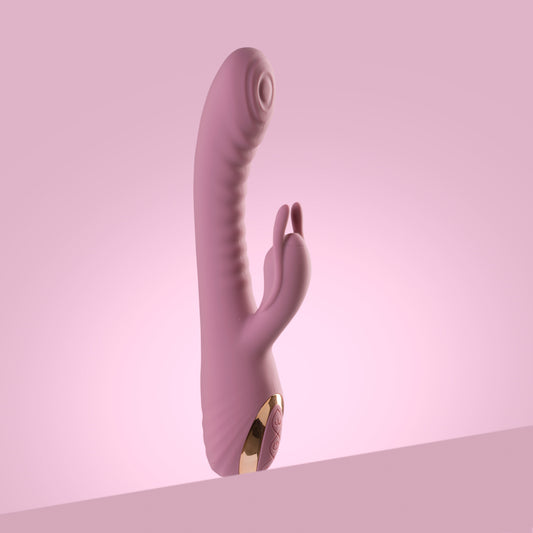Pink rabbit vibrator standing upright on pink background

