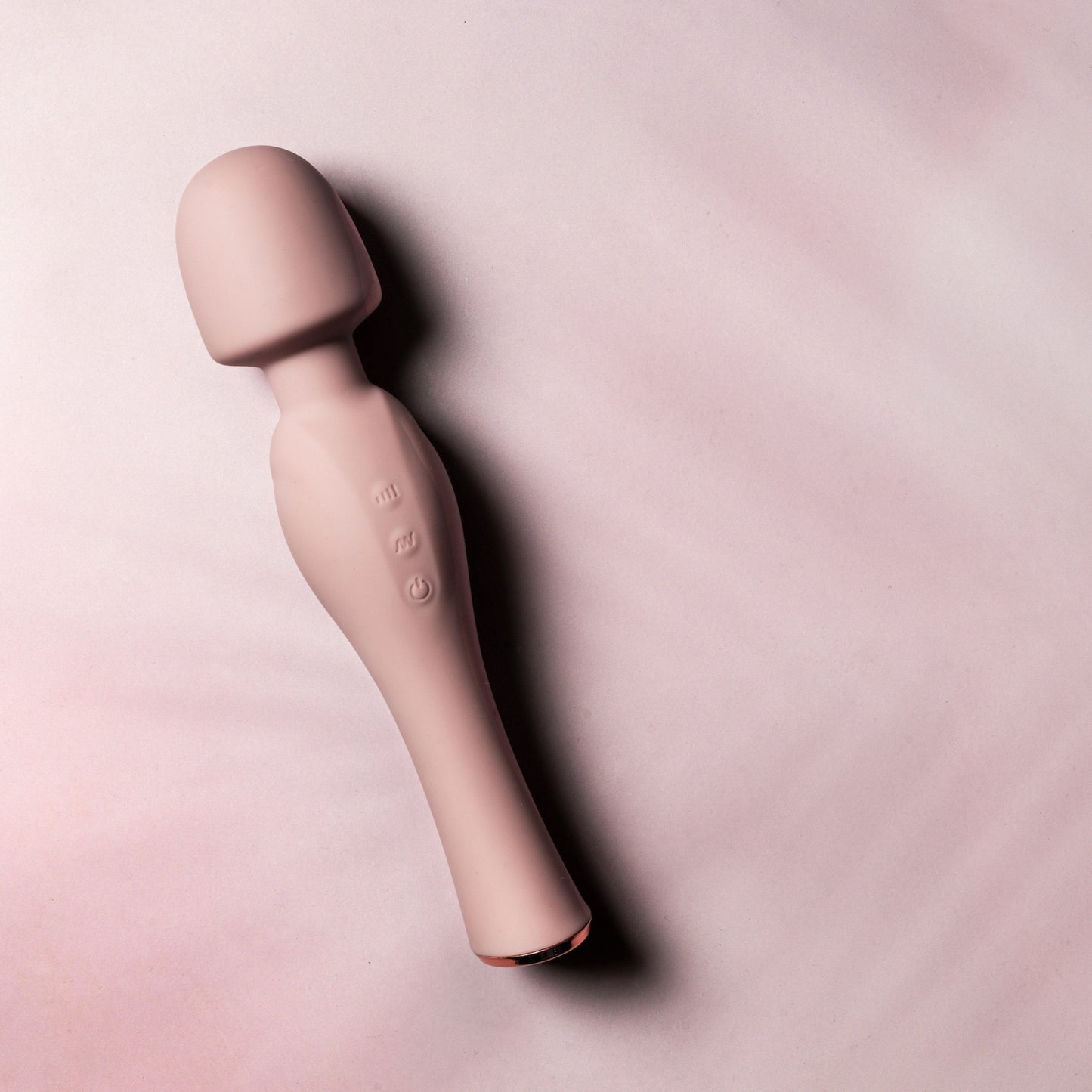 Pink wand vibrator massager on a pink background
